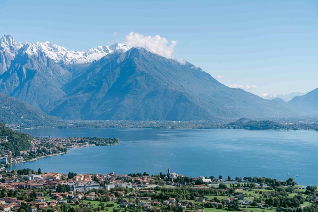 Scenic panoramic view of Lake Como with mountains, villas and golden sunset light