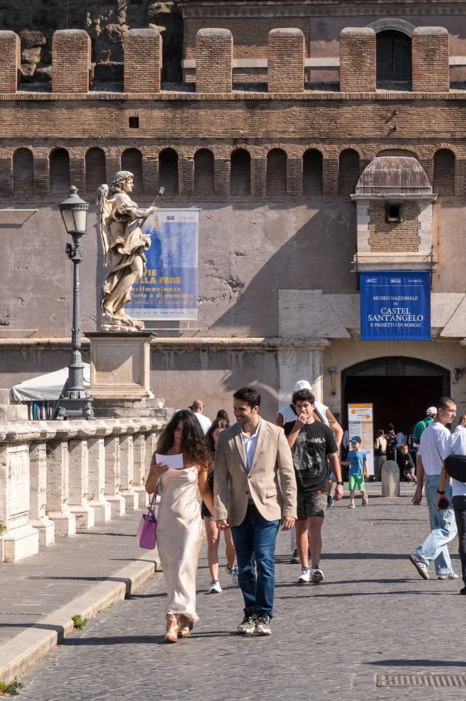 Raul and Cris walking across Ponte Sant'Angelo before their surprise proposal